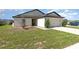Attractive home with a well-maintained lawn, inviting entrance, and an attached two-car garage at 1741 Canaan Loop, Dundee, FL 33838