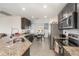 Well-equipped kitchen overlooking the dining area, with stainless steel appliances and granite countertops at 1741 Canaan Loop, Dundee, FL 33838