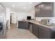 Eat-in kitchen featuring dark wood cabinets, granite countertops, and stainless steel appliances, connecting to living space at 1741 Canaan Loop, Dundee, FL 33838