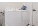 Clean laundry room area features a white washer and dryer and utility accessories for convenient chores at 1741 Canaan Loop, Dundee, FL 33838