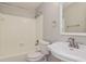 Bathroom featuring a white vanity, framed mirror, and a shower over tub at 248 Lake Thomas Dr, Winter Haven, FL 33880