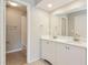 Bathroom featuring double vanity and a walk-in shower with white subway tile at 248 Lake Thomas Dr, Winter Haven, FL 33880