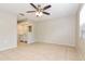 Spacious primary bedroom with tile floors, ceiling fan, and an attached vanity area at 248 Lake Thomas Dr, Winter Haven, FL 33880