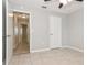 Cozy bedroom featuring neutral paint, tile flooring, and a spacious closet at 248 Lake Thomas Dr, Winter Haven, FL 33880