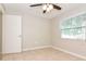 Bedroom with tiled flooring, ceiling fan, and a window for natural light at 248 Lake Thomas Dr, Winter Haven, FL 33880