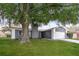Charming single-Gathering home featuring a mature tree and a well-maintained front lawn at 248 Lake Thomas Dr, Winter Haven, FL 33880