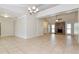 Open-concept living room featuring tile floors, a brick fireplace, and natural light at 248 Lake Thomas Dr, Winter Haven, FL 33880