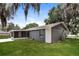 Exterior of home with screened in porch overlooking the backyard and mature trees at 248 Lake Thomas Dr, Winter Haven, FL 33880