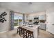 Stylish kitchen featuring a center island with breakfast bar, stainless steel appliances, and a sliding glass door at 4019 Gardenia Ave, Lake Hamilton, FL 33851