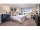 Spacious main bedroom boasts natural light, a comfortable bed, and stylish decor at 4019 Gardenia Ave, Lake Hamilton, FL 33851