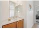 Bathroom with a corner sink and vanity, one mirror, and view of a shower with curtain and office at 448 Sorrento Rd, Kissimmee, FL 34759