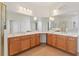Spacious bathroom with tile flooring, dual sinks, vanity and ample lighting with a large mirror at 448 Sorrento Rd, Kissimmee, FL 34759