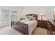 A well-lit bedroom with a padded headboard bed, two side tables, and neutral decor at 448 Sorrento Rd, Kissimmee, FL 34759