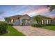 Charming single-story home featuring a well-maintained lawn, brick driveway, and inviting entrance at 448 Sorrento Rd, Kissimmee, FL 34759