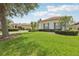 Well-maintained front yard of a house with lush green grass and landscaping at 448 Sorrento Rd, Kissimmee, FL 34759