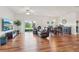Bright and airy living area featuring hardwood floors, neutral paint, and sliding door access to the outdoors at 448 Sorrento Rd, Kissimmee, FL 34759