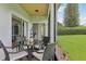 Outdoor patio with a table, chairs, and a view of the lawn and trees at 448 Sorrento Rd, Kissimmee, FL 34759