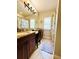 Well-lit bathroom featuring double sink vanities, granite countertop, and shower-tub combo at 5489 Baldwin Park St, Orlando, FL 32814