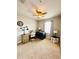 Bedroom with desk and chair, dog cage, a large window and neutral walls at 5489 Baldwin Park St, Orlando, FL 32814