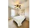 Comfortable bedroom with soft white bedding, rustic wood decor, and natural light at 5489 Baldwin Park St, Orlando, FL 32814