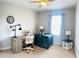 Bedroom with desk and chair, dog cage, a large window and neutral walls at 5489 Baldwin Park St, Orlando, FL 32814