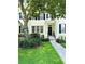 Inviting two-story home features lush landscaping, a charming front porch, and classic black shutters at 5489 Baldwin Park St, Orlando, FL 32814
