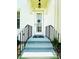 Inviting front entrance with black railings leading up to a white door, welcoming guests at 5489 Baldwin Park St, Orlando, FL 32814