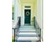 Close-up of the front door featuring decorative wreath, elegant columns, and steps leading to the entrance at 5489 Baldwin Park St, Orlando, FL 32814