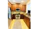 Well-lit kitchen features stainless appliances, granite countertops, and tile flooring at 5489 Baldwin Park St, Orlando, FL 32814