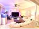 Cozy living room with stylish furniture, unique lighting, and a ceiling fan, perfect for relaxation at 5489 Baldwin Park St, Orlando, FL 32814