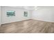Spacious bedroom featuring wood-look floors, two windows and modern ceiling fans at 5525 Tillman Rd, Lakeland, FL 33810