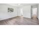 Spacious bedroom with modern gray flooring, ensuite bathroom access, and a window view of the outdoors at 5525 Tillman Rd, Lakeland, FL 33810