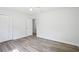 Bright bedroom featuring modern flooring and white walls with natural light and spacious closet at 5525 Tillman Rd, Lakeland, FL 33810