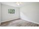 Bright bedroom with wood-look flooring and a window overlooking the backyard at 5525 Tillman Rd, Lakeland, FL 33810