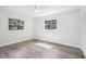 Bright bedroom with modern flooring, two windows, and a spacious closet for optimal storage at 5525 Tillman Rd, Lakeland, FL 33810