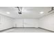 Spacious two car garage featuring smooth floors and white walls at 5525 Tillman Rd, Lakeland, FL 33810