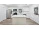 Modern kitchen with white cabinets, island, and stainless steel appliances at 5525 Tillman Rd, Lakeland, FL 33810