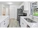 Bright kitchen boasts white cabinetry, stainless steel appliances, and quartz countertops at 5525 Tillman Rd, Lakeland, FL 33810