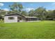 The backyard showcases a vast screened-in patio and lush lawn at 5525 Tillman Rd, Lakeland, FL 33810