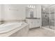 Bright bathroom featuring a soaking tub and a glass enclosed shower at 8875 Backspin Ln, Champions Gate, FL 33896