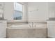 Bathroom features a large tub, window, and tiled surround at 8875 Backspin Ln, Champions Gate, FL 33896