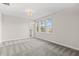 Spacious, light-filled bedroom with three windows, plush carpeting, and neutral walls with a view at 8875 Backspin Ln, Champions Gate, FL 33896