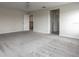 Spacious bedroom with neutral carpet, light fixture, and hallway access at 8875 Backspin Ln, Champions Gate, FL 33896