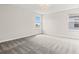 Bright bedroom with neutral carpet and plenty of natural light from two large windows at 8875 Backspin Ln, Champions Gate, FL 33896