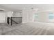 Bright and spacious bonus room with plush carpeting, multiple windows, staircase, and neutral walls at 8875 Backspin Ln, Champions Gate, FL 33896