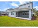 View of the back of the house featuring a covered patio with lush lawn at 8875 Backspin Ln, Champions Gate, FL 33896