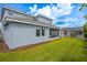 Back of the home featuring a covered patio overlooking a lush green lawn and pool area at 8875 Backspin Ln, Champions Gate, FL 33896