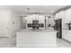 Bright kitchen features an island, modern appliances, stylish pendant lighting, and dark backsplash at 8875 Backspin Ln, Champions Gate, FL 33896