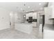 Modern kitchen offers an island, dark backsplash, stainless appliances, and open layout at 8875 Backspin Ln, Champions Gate, FL 33896