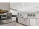Bright kitchen with white cabinets, stainless steel appliances, island and backyard views at 8875 Backspin Ln, Champions Gate, FL 33896